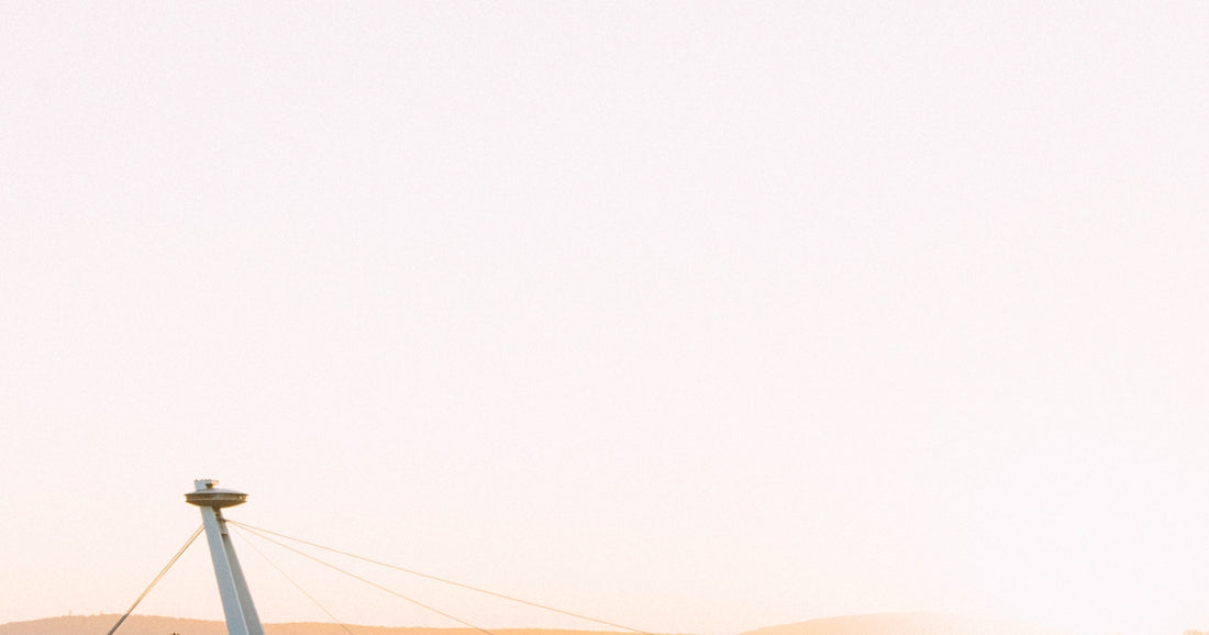 a man flying a kite on top of a sandy beach