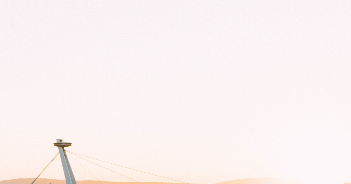 a man flying a kite on top of a sandy beach
