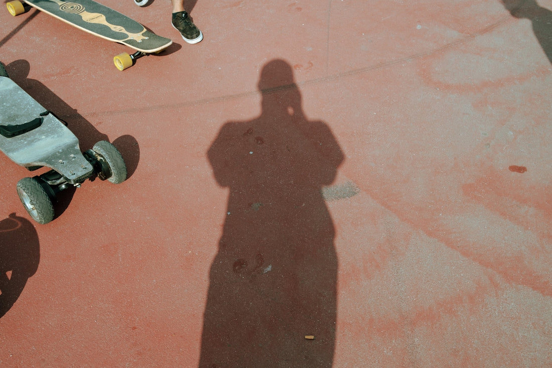 person in black shoes standing on brown concrete floor