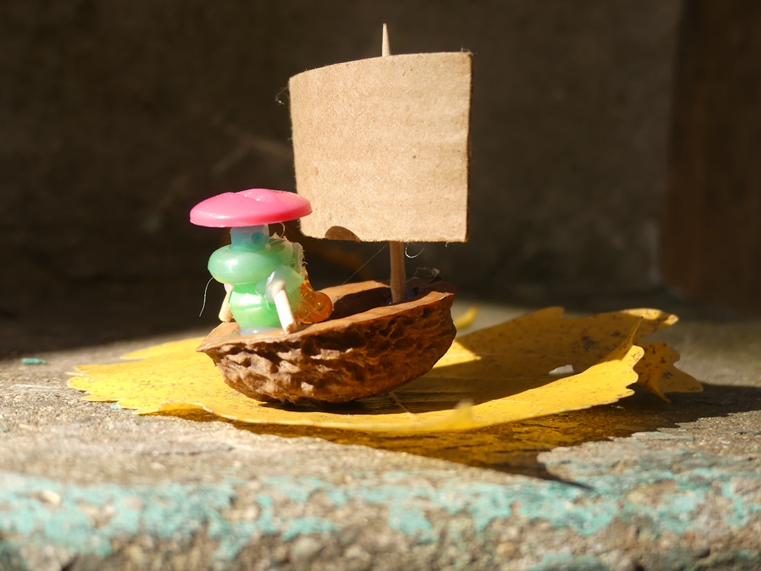 a small toy boat with a small figure on it